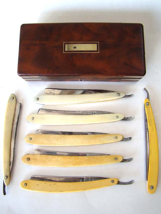 A fine cased set of seven straight edge razors with ivory and bone handles in a brass bound walnut box circa 1850